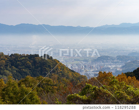 Shigisan with its autumn leaves and the misty streets of the Nara Basin Shigisan with its autumn leaves and the misty streets of the Nara Basin 118295288