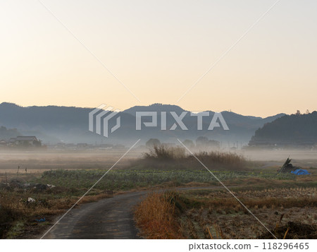 The rural landscape of Asuka Village shrouded in autumn mist 118296465
