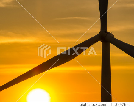 Wind farm field and sunset sky. Wind power. Sustainable, renewable energy. Wind turbines generate electricity. Sustainable development. Green technology for energy sustainability. Eco-friendly energy. 118297663