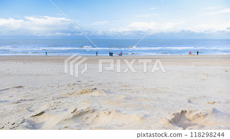 Wide Sandy Beach with People Strolling at Low Tide 118298244