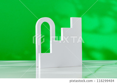 Decorative podiums on green background in studio 118299484