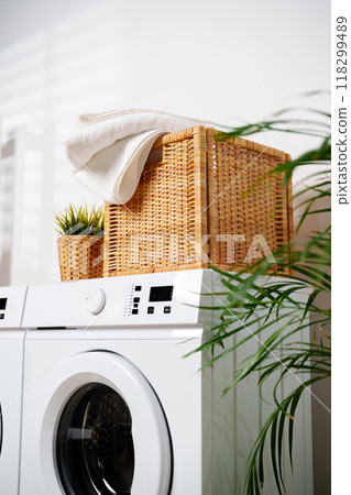 White Towels In Wicker Basket On Top Of White Washing Machine White Towels In Wicker Basket On Top Of White Washing Machine 118299489