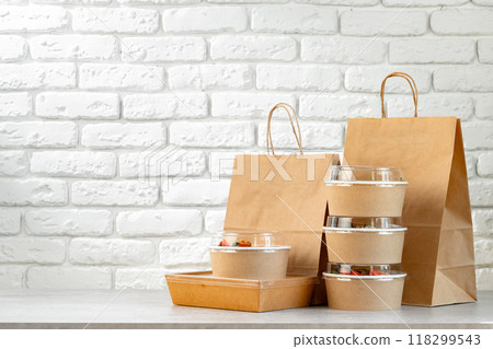 Take out food in boxes and craft bag against brick background Take out food in boxes and craft bag against brick background 118299543
