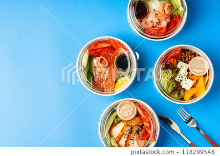 Different poke bowls on blue background top view 118299548