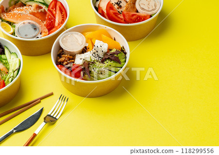 Side view of fresh poke bowls on yellow background 118299556
