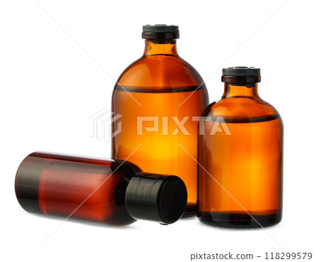 Three Amber Glass Bottles Filled With Liquid on White Background 118299579