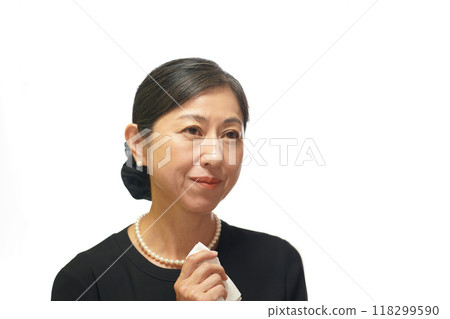 A middle-aged woman wearing mourning clothes wiping away tears with a white handkerchief A middle-aged woman wearing mourning clothes wiping away tears with a white handkerchief 118299590
