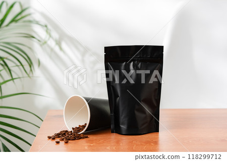 Three beverage containers and a paper bag on a wooden table Three beverage containers and a paper bag on a wooden table 118299712