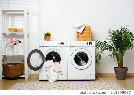 Modern Laundry Room With White Washing Machines and Open Door 118299927
