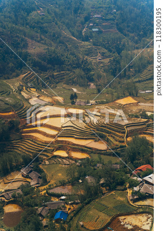Behold the Stunning Aerial View of Terraced Rice Fields Set Against a Lush, Vibrant Landscape 118300195