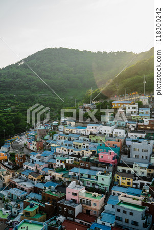 Colorful hillside homes of Busan basking in warm sunlight during a serene late afternoon 118300242