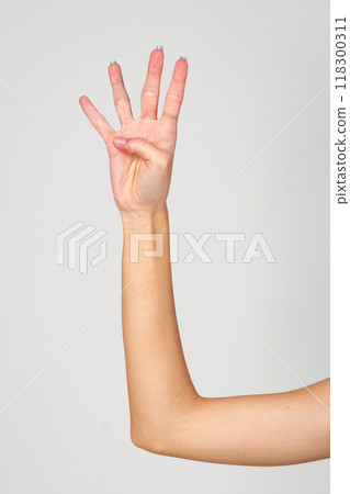 Womans Hand With Blue Nail Polish on gray background. Womans Hand With Blue Nail Polish on gray background. 118300311