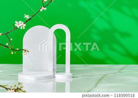 Decorative podiums and blooming branches on green background with shadows 118300518