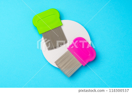 Comb for lice removing on blue background Comb for lice removing on blue background 118300537