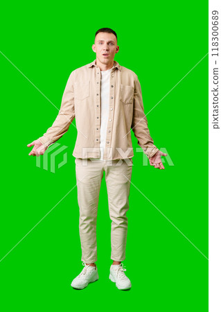 Confused Young Man Standing Against Bright Green Background With Open Arms in Uncertain Gesture 118300689