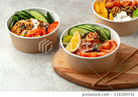 Tasty poke bowls on gray textured surface Tasty poke bowls on gray textured surface 118300742