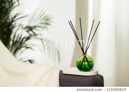 Aroma diffuser bottle with sticks in living room Aroma diffuser bottle with sticks in living room 118300824
