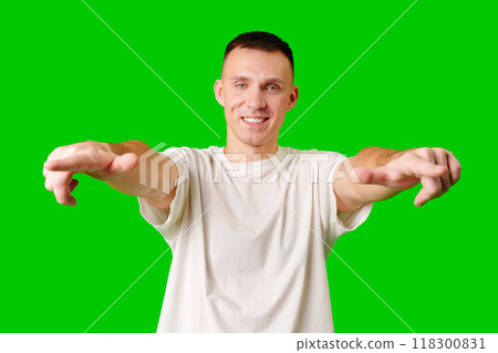 Young Man Posing Playfully in Casual Attire With Green Background 118300831