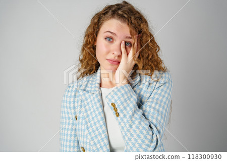 Young Woman Covering Face With Hands in Studio Young Woman Covering Face With Hands in Studio 118300930