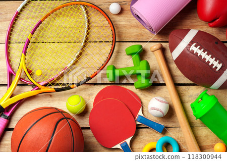 Different sports equipment on wooden background top view 118300944