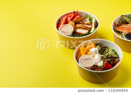 Side view of fresh poke bowls on yellow background Side view of fresh poke bowls on yellow background 118300954