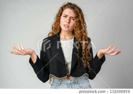 Young Curly Clueless Woman Holding Out Hands Young Curly Clueless Woman Holding Out Hands 118300959