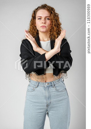 Young Woman Standing With Her Arms Crossed 118300989