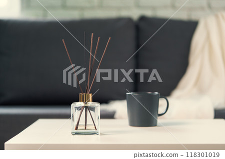 Aroma diffuser bottle with sticks in living room 118301019