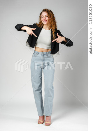 Woman in Crop Top and Jeans Pointing Down Woman in Crop Top and Jeans Pointing Down 118301020