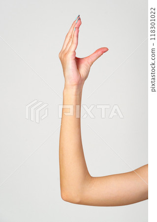 Womans Hand With Blue Nail Polish on gray background. 118301022