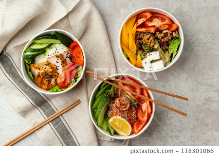 Beautiful composition with poke bowls on gray background with napkin 118301066