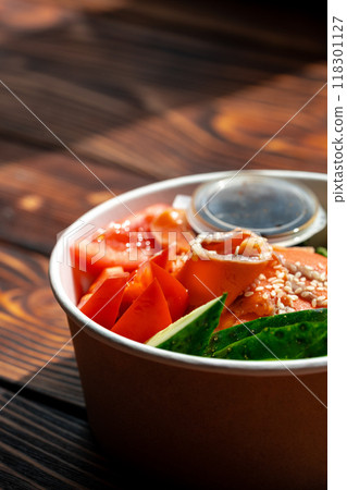 Poke bowl with salmon on wooden background Poke bowl with salmon on wooden background 118301127