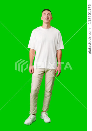 Young Man With Short Hair Smiling Against a Bright Green Background Young Man With Short Hair Smiling Against a Bright Green Background 118301176