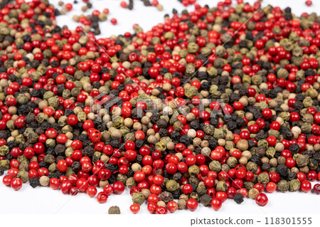 Red, green, white and black peppercorns on a white background Red, green, white and black peppercorns on a white background 118301555