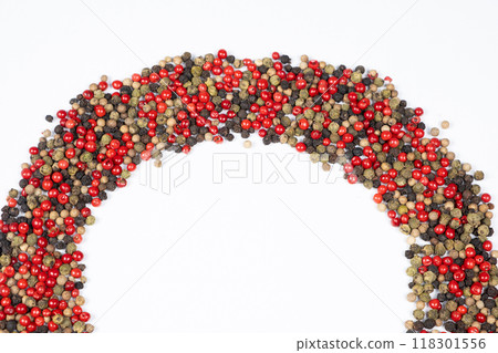 Frame of different varieties of peppercorns on a white background, top view, place for text. Frame of different varieties of peppercorns on a white background, top view, place for text. 118301556