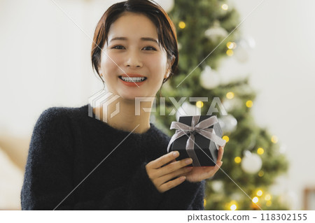 A woman with a Christmas gift 118302155