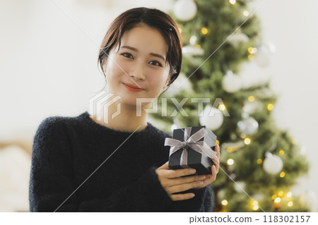 A woman with a Christmas gift 118302157