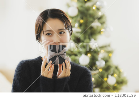 A woman with a Christmas gift 118302159