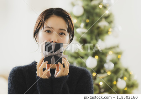 A woman with a Christmas gift 118302160