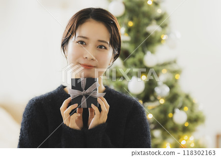 A woman with a Christmas gift 118302163