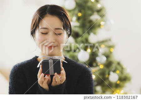A woman with a Christmas gift 118302167