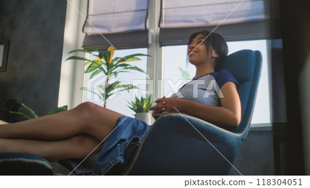 African American teenage girl sits in chair, talks during counseling session 118304051