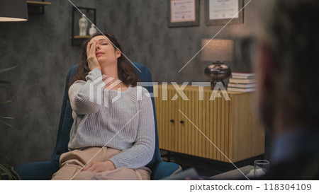Depressed female patient on counseling session with psychologist 118304109