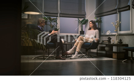 Mature psychotherapist talks with female patient, provides therapy Mature psychotherapist talks with female patient, provides therapy 118304125
