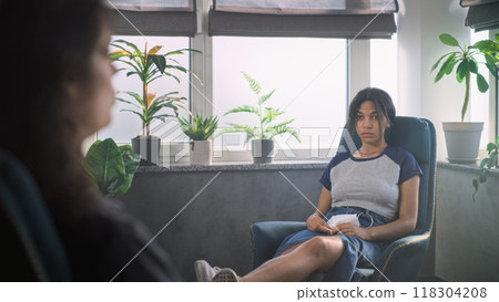 Close up of female psychotherapist talking with teenager, providing psychotherapy 118304208