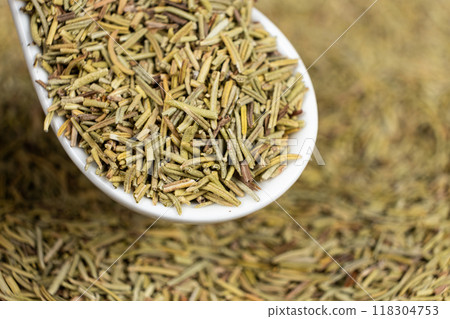 Spoon seasoning dry chopped rosemary close-up 118304753