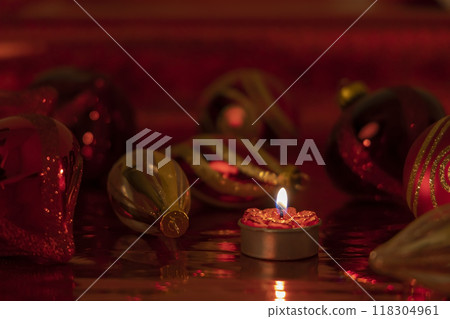 Christmas still life with red baubles and candle Christmas still life with red baubles and candle 118304961