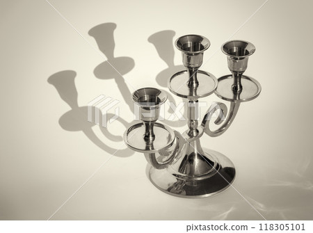 Golden candlestick on a white background Golden candlestick on a white background 118305101