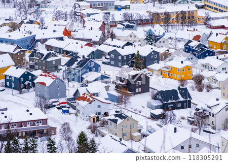 Norwegian town of Troms in the winter. Snowy arctic city with colorful houses and port Norwegian town of Troms in the winter. Snowy arctic city with colorful houses and port 118305291