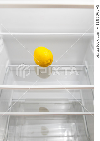 refrigerator with single lemon on glass shelf refrigerator with single lemon on glass shelf 118306349